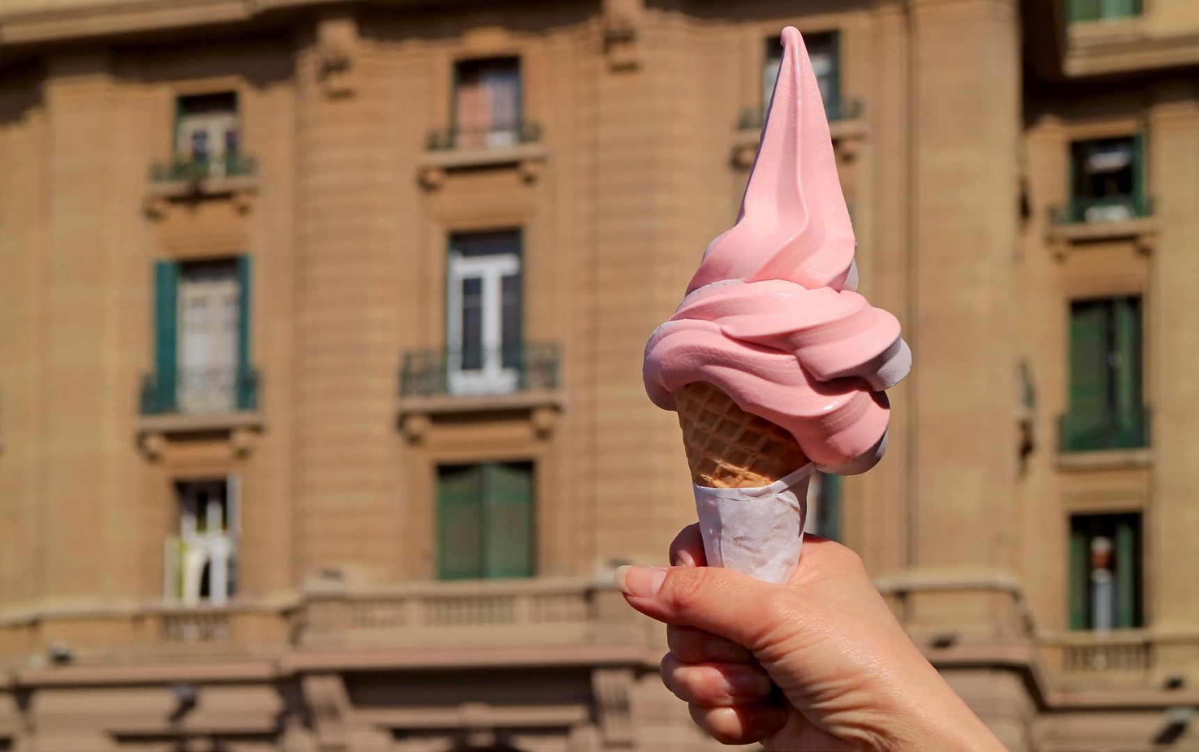 soft serve ice cream cone Woman outdoor at summer sunset time having ice cream cone positive happy playful at city street
