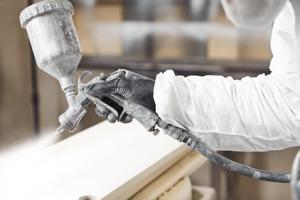 closeup-industrial-worker-using-paint-gun-spray-gun-applying-paint-application-flame-retardant-ensuring-fire-protection-airless-spraying (Large)