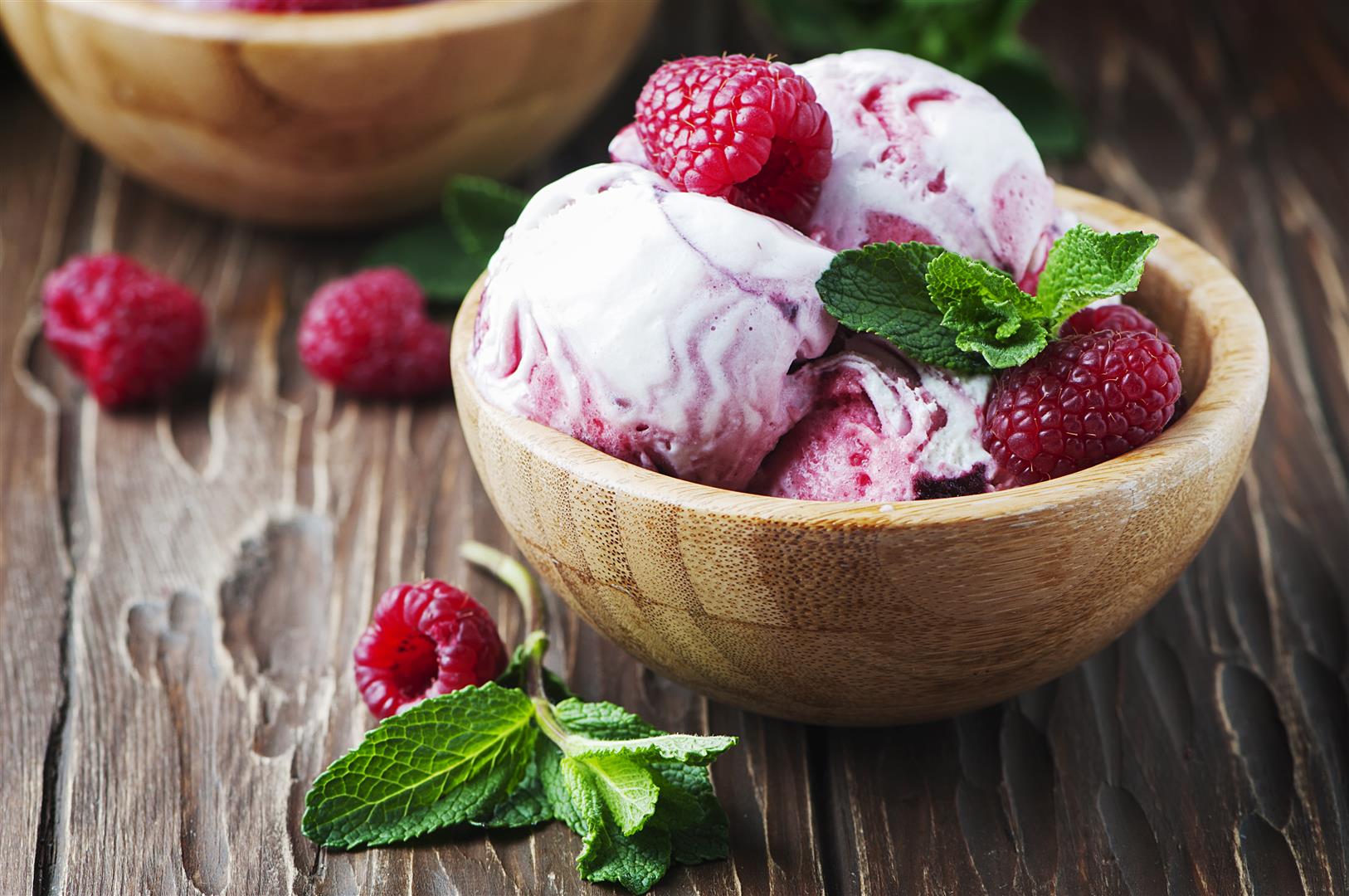 Delicious ice-cream witn mint and raspberry, selective focus Delicious ice-cream witn mint and raspberry, selective focus