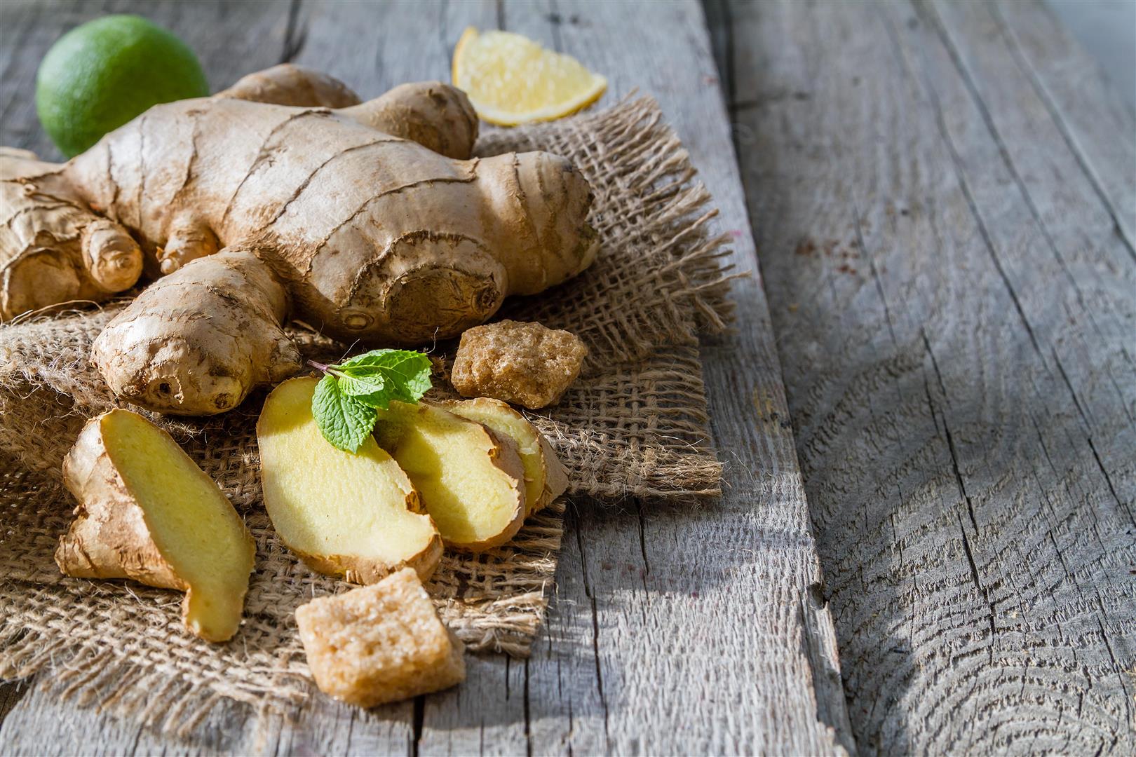Ginger lemon mint honey on rustic wood background, copy space Various cheeses
