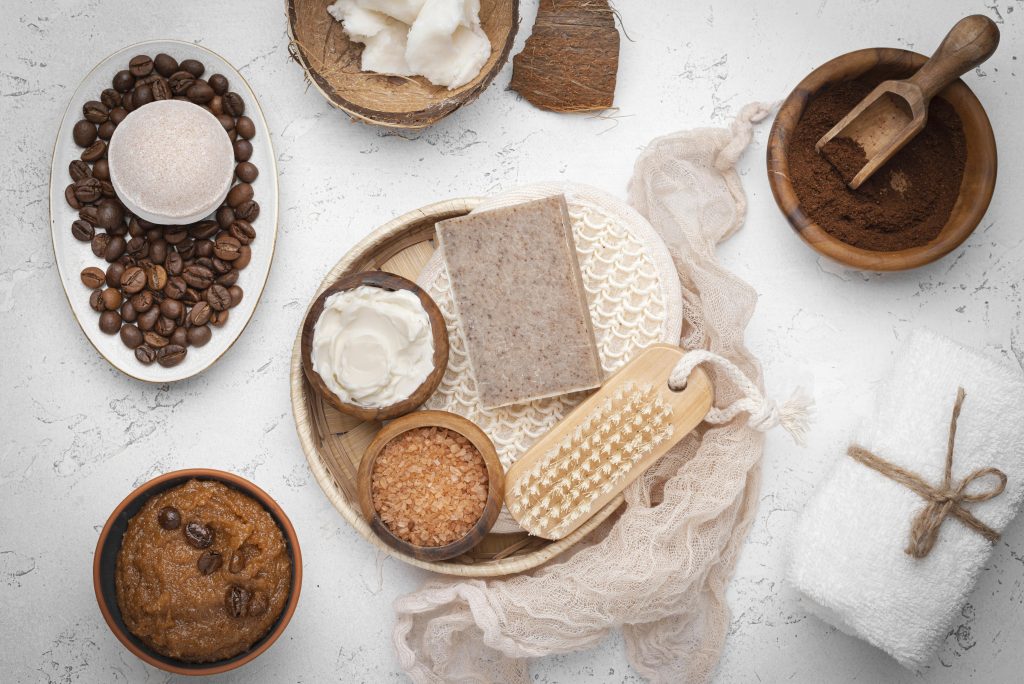 homemade-remedy-with-coffee-beans Natural body care set with coffee scrub, coconut oil, bath salts, soap and a wooden brush.
