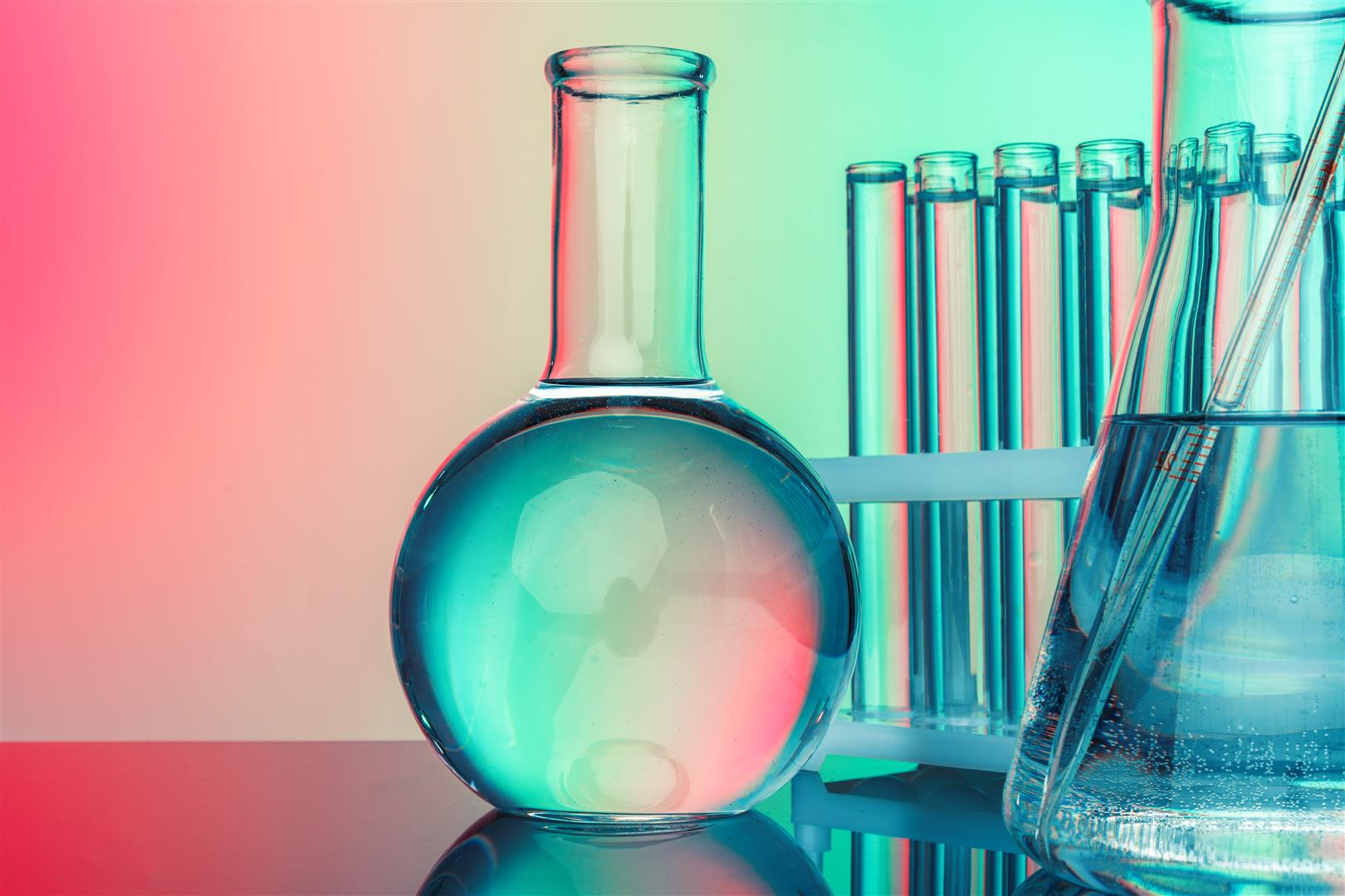 Laboratory chemistry glassware on green toned background Research and development concept. Double exposure image of microbiology and chemistry in laboratory for medicine study.