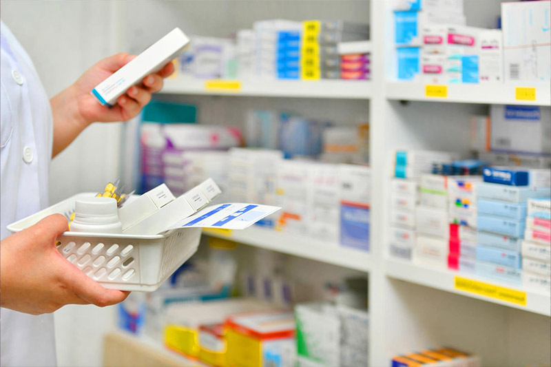 lady-at-pharmacy-checking-out-medications-in-a-basket lady-at-pharmacy-checking-out-medications-in-a-basket