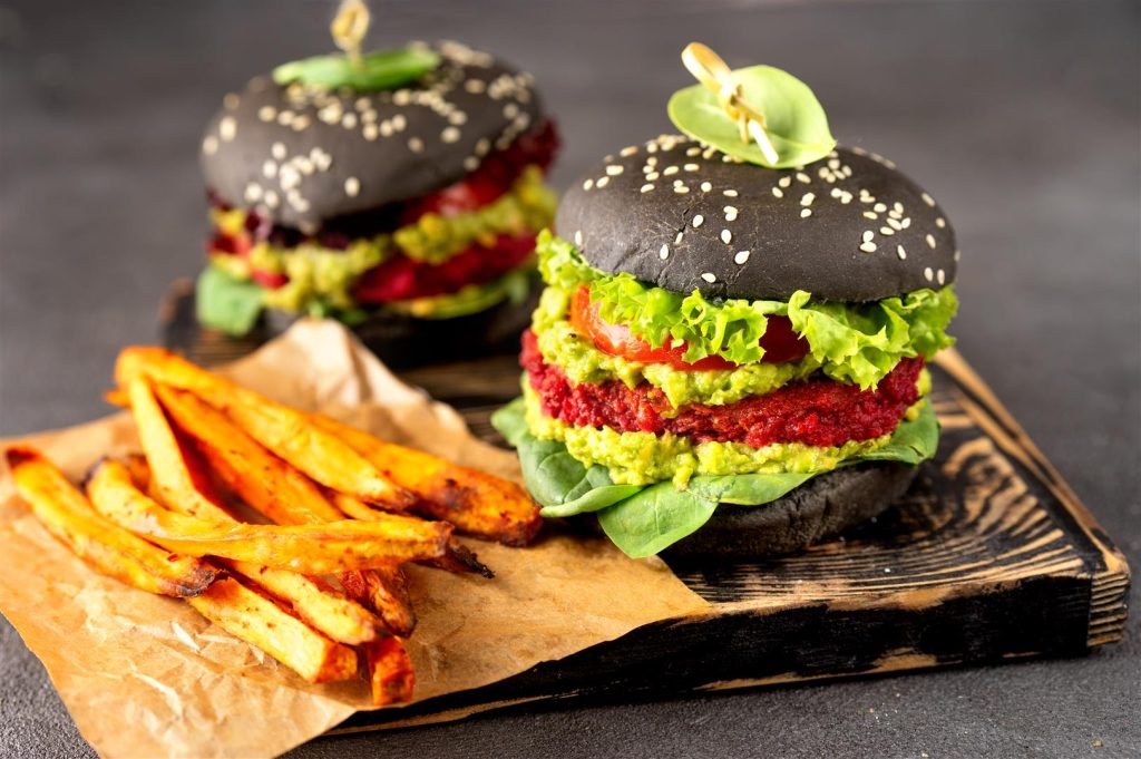 Close up of two vegan black burgers with fried sweet potato two-vegan-black-burgers-with-fried-sweet-potato